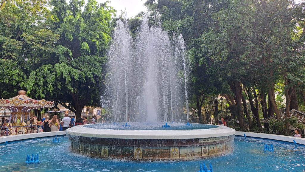 A water fountain with people in the background